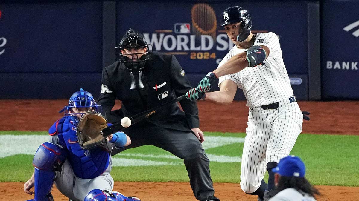 New York Yankees designated hitter Giancarlo Stanton (27) hits an RBI sacrifice fly during the sixth inning against the Los Angeles Dodgers in game four of the 2024 MLB World Series at Yankee Stadium.