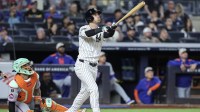 New York Yankees left fielder Cody Bellinger (35) hits a grand slam home run in the eighth inning against the New York Mets at Yankee Stadium.