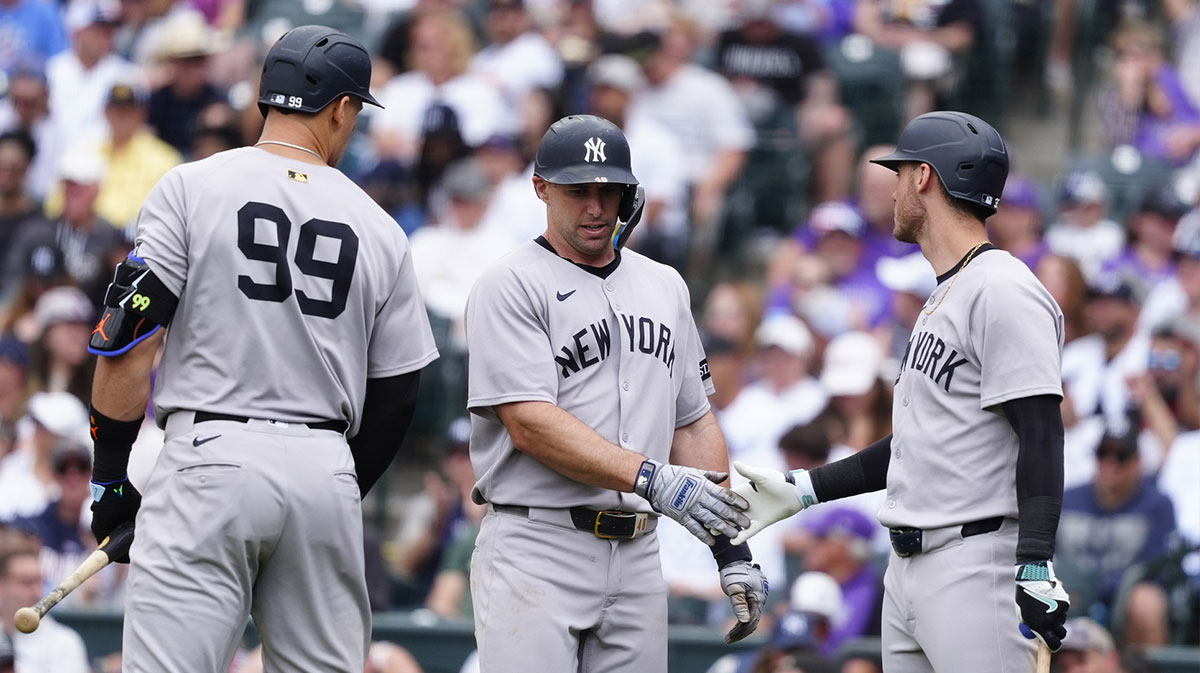 New York Yankees first base Paul Goldschmidt (48) celebrates scoring a run with right fielder Aaron Judge (99) and left fielder Cody Bellinger (35) in the fifth inning against the Colorado Rockies at Coors Field.