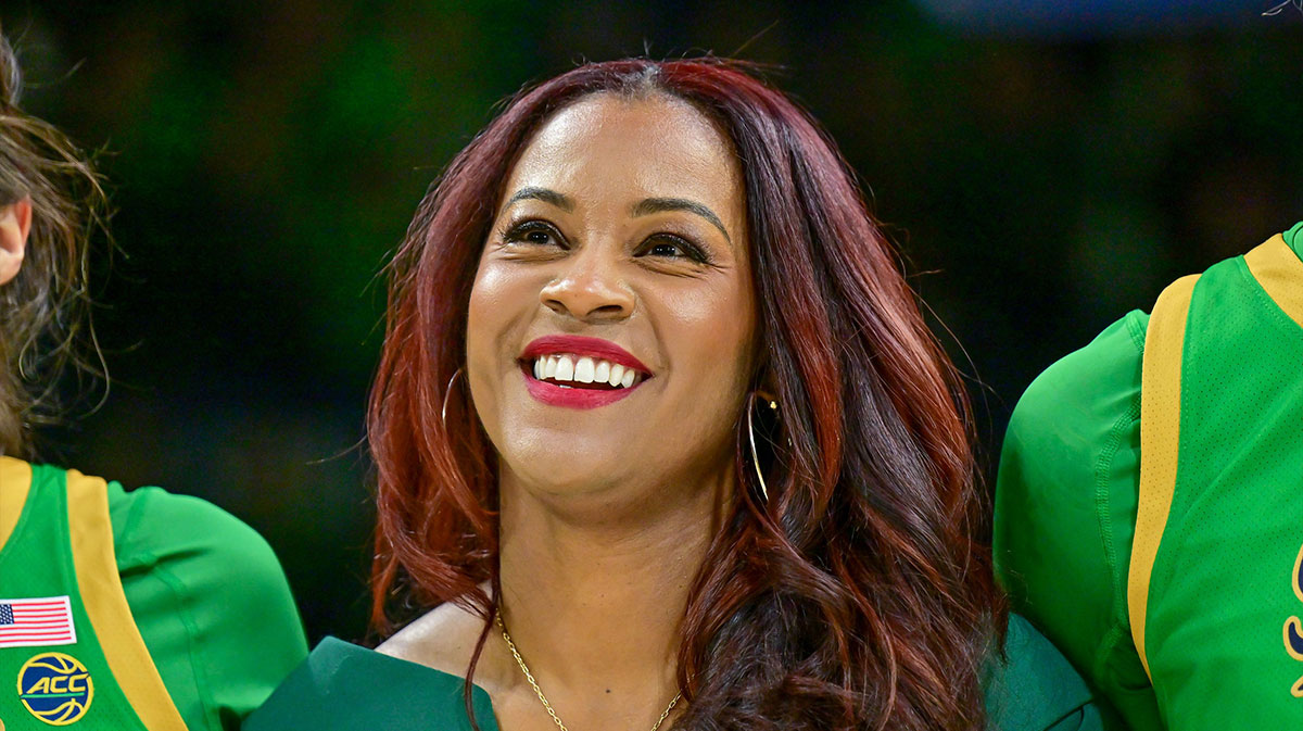 Notre Dame Fighting Irish head coach Niele Ivey smiles as she stands with her players for the Notre Dame Alma Mater after defeating the Louisville Cardinals 72-59 at the Purcell Pavilion.