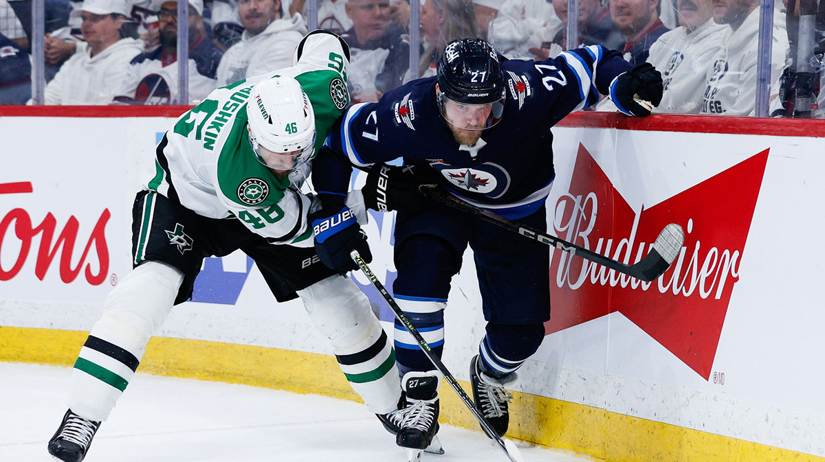 Winnipeg Jets forward Nikolaj Ehlers (27) and Dallas Stars defenseman Ilya Lyubushkin (46) skate for the puck during the second period in game five of the second round of the 2025 Stanley Cup Playoffs at Canada Life Centre.