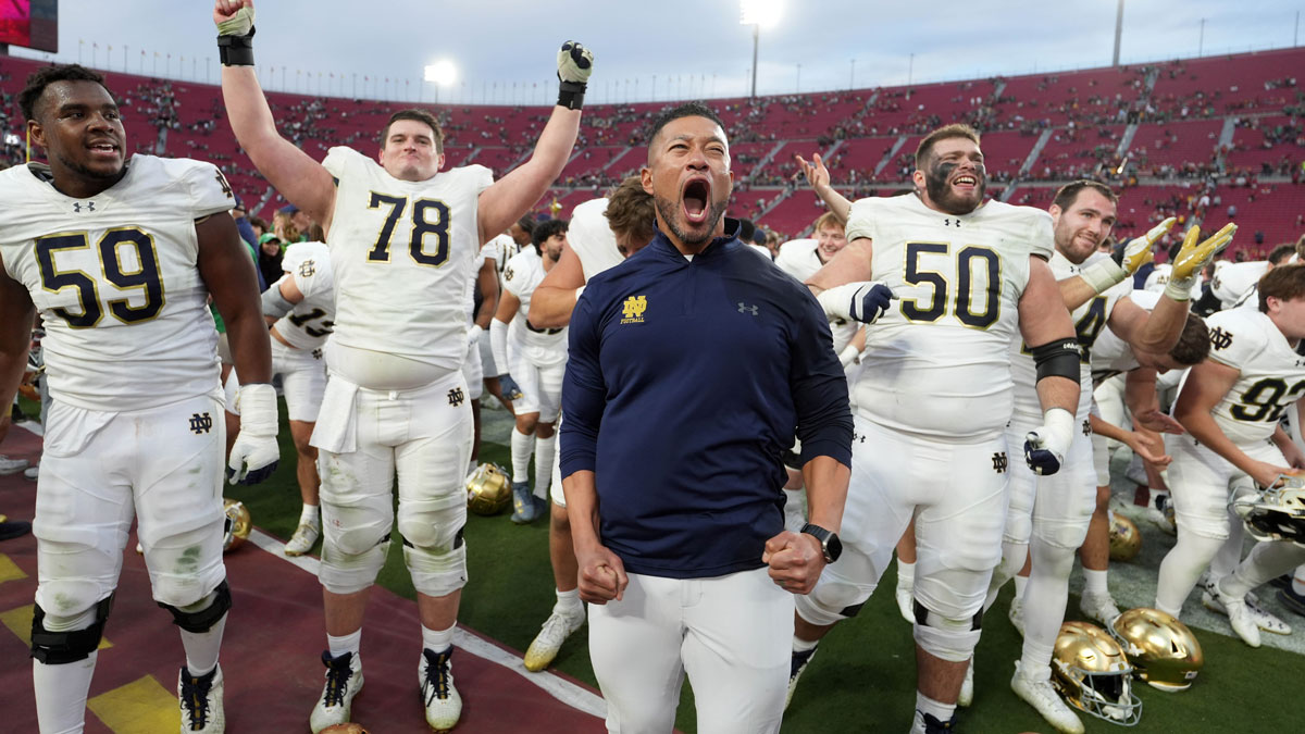 Notre Dame Fighting Irish head coach Marcus Freeman celebrates with players at the end of the game against the Southern California Trojans at United Airlines Field at Los Angeles Memorial Coliseum.
