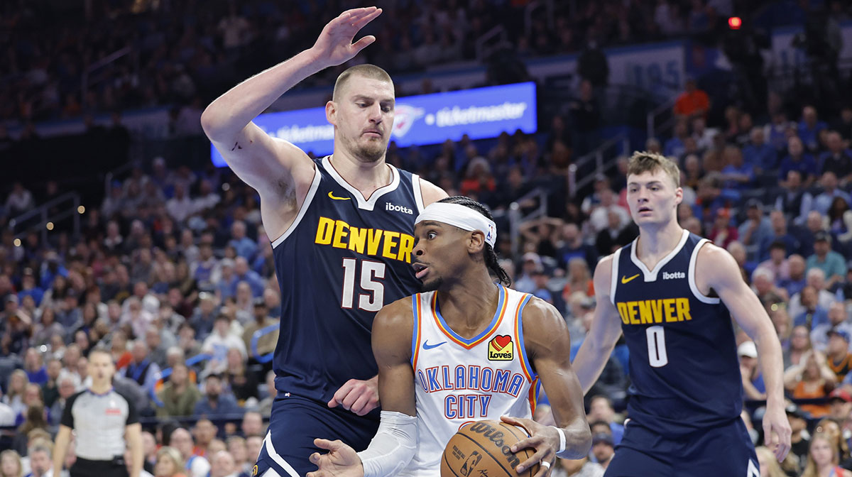 Nuggets center Nikola Jokic (15) defends a drive by Oklahoma City Thunder guard Shai Gilgeous-Alexander (2) during the second half at Paycom Center