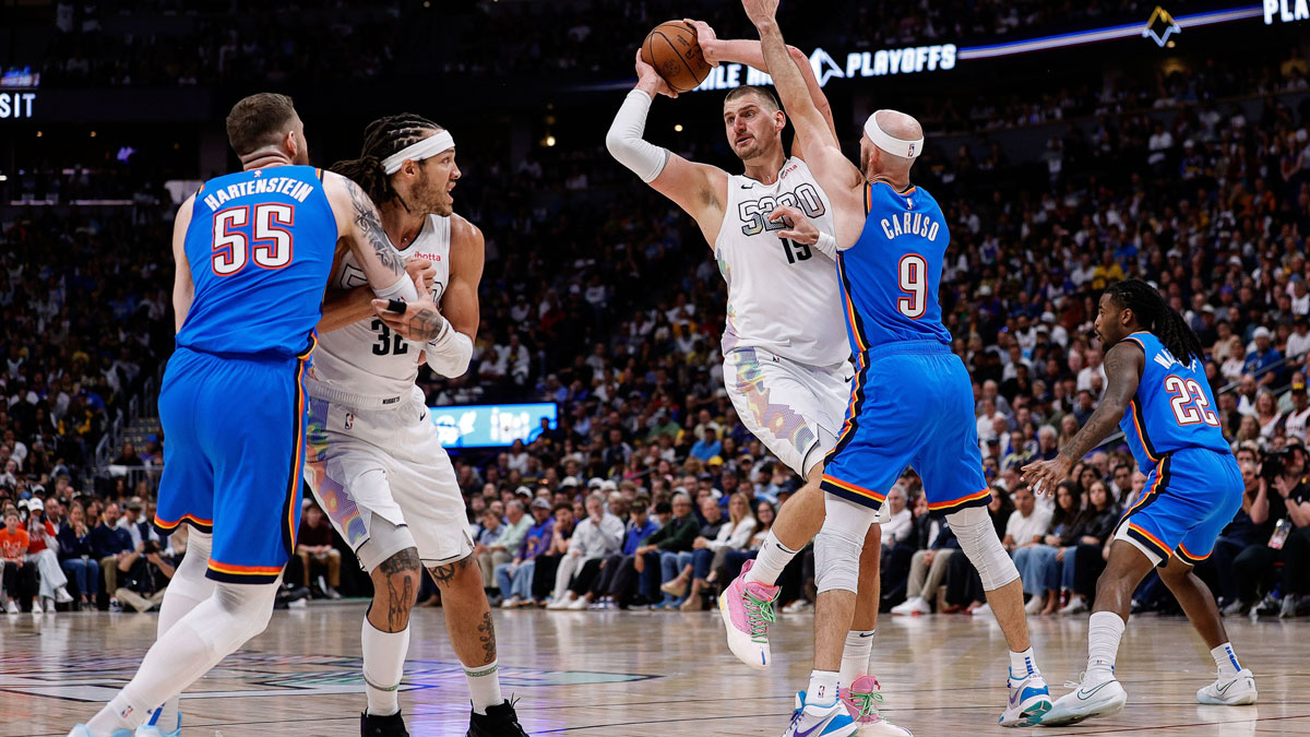 Denver Nuggets center Nikola Jokic (15) looks to pass the ball under pressure from Oklahoma City Thunder guard Alex Caruso (9) as center Isaiah Hartenstein (55) and forward Aaron Gordon (32) battle for position in the third quarter during game six of the second round for the 2025 NBA Playoffs at Ball Arena.