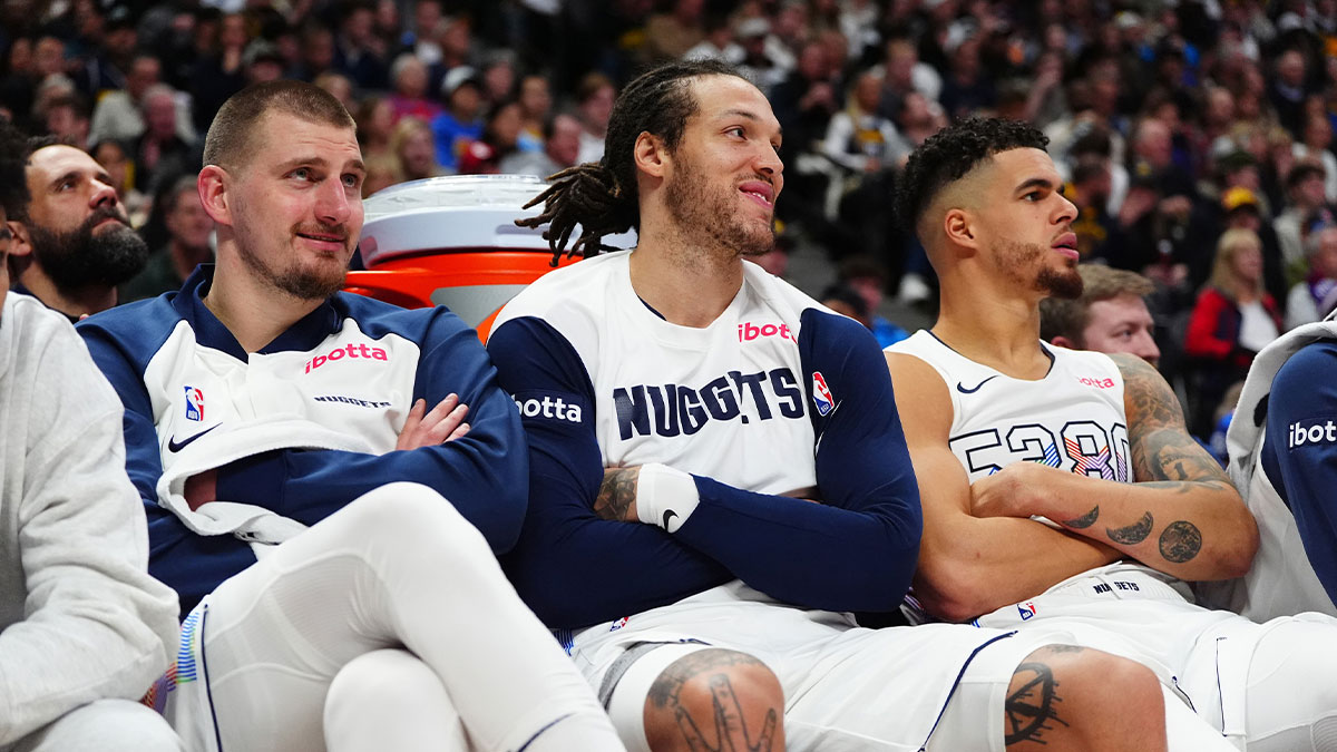 Denver Nuggets center Nikola Jokic (15) and forward Aaron Gordon (32) and forward Michael Porter Jr. (1) on the bench in the fourth quarter against the Phoenix Suns at Ball Arena.