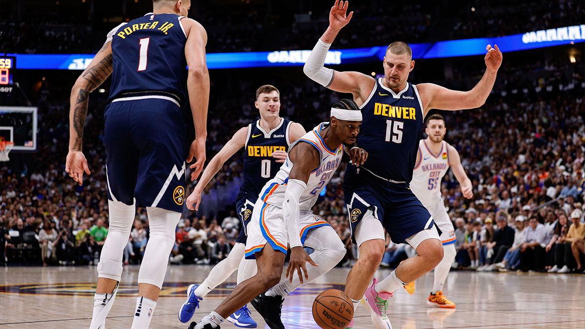 Oklahoma City Thunder guard Shai Gilgeous-Alexander (2) controls the ball against Denver Nuggets center Nikola Jokic (15) and guard Christian Braun (0) and forward Michael Porter Jr. (1) in the first quarter during game four of the second round of the 2025 NBA Playoffs at Ball Arena.
