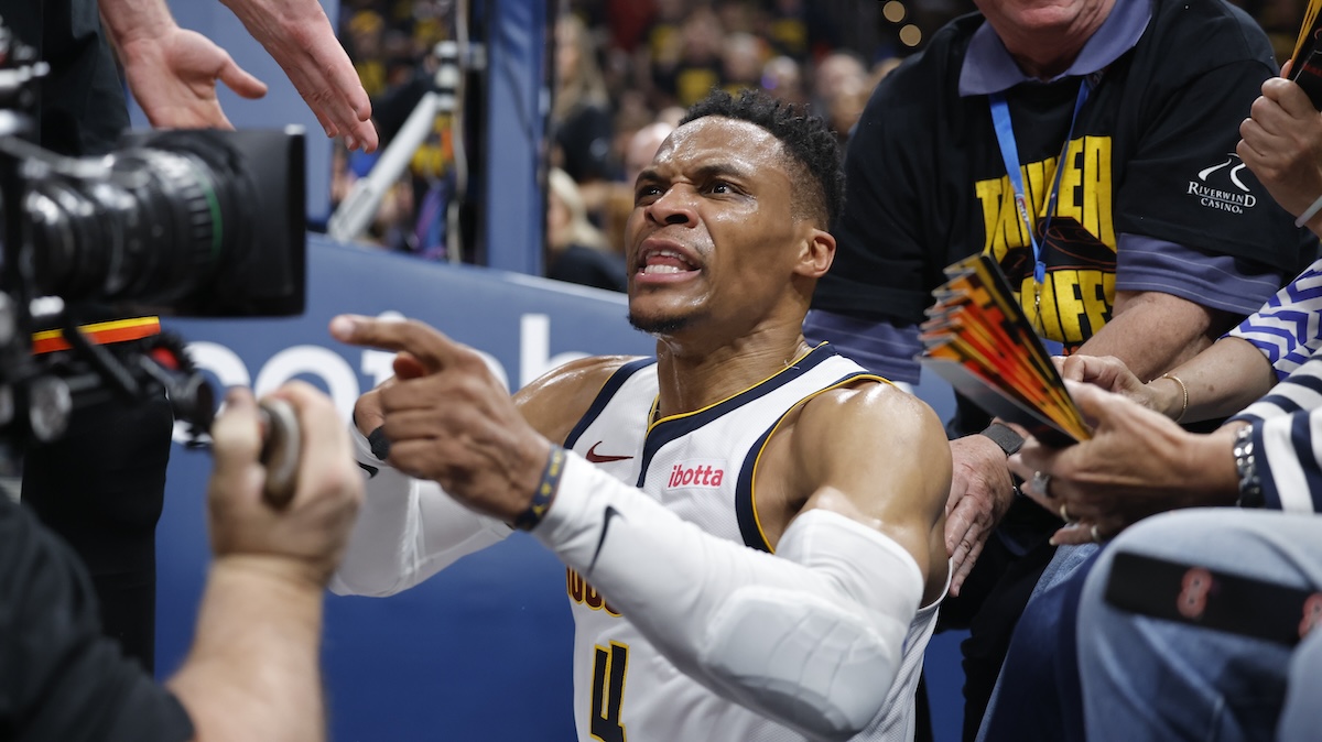 Nuggets guard Russell Westbrook (4) reacts after a play and falling into fans in the second quarter against the Oklahoma City Thunder during game two of the second round for the 2025 NBA Playoffs at Paycom Center