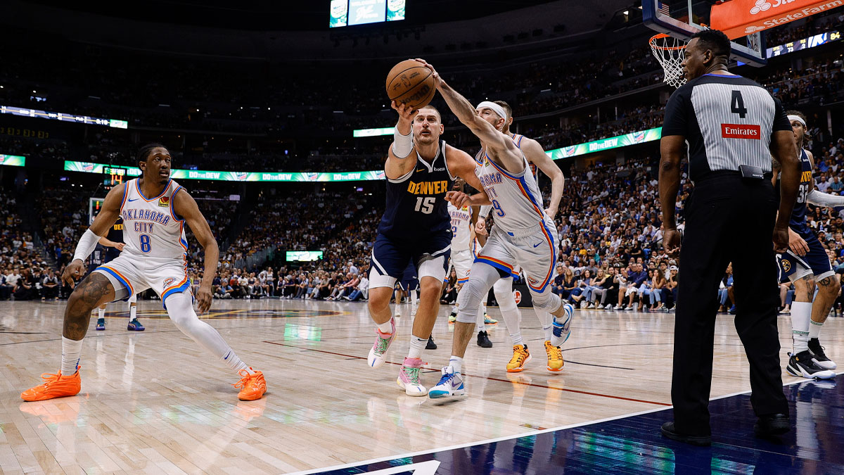 Denver Nuggets center Nikola Jokic (15) and Oklahoma City Thunder guard Alex Caruso (9) battle for a loose ball as forward Jalen Williams (8) and referee Sean Wright (4) look on in the fourth quarter during game four of the second round of the 2025 NBA Playoffs at Ball Arena.
