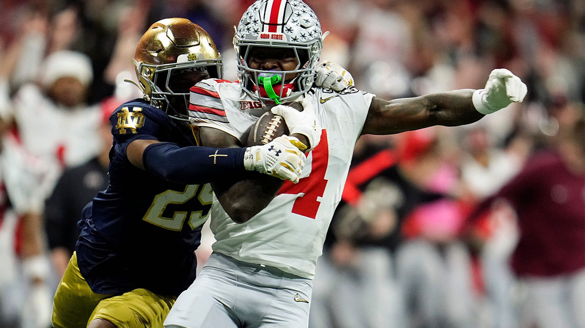 Ohio State Buckeyes wide receiver Jeremiah Smith (4) makes a catch against Notre Dame Fighting Irish cornerback Christian Gray (29) in the fourth quarter during the College Football Playoff National Championship at Mercedes-Benz Stadium in Atlanta on January 20, 2025.