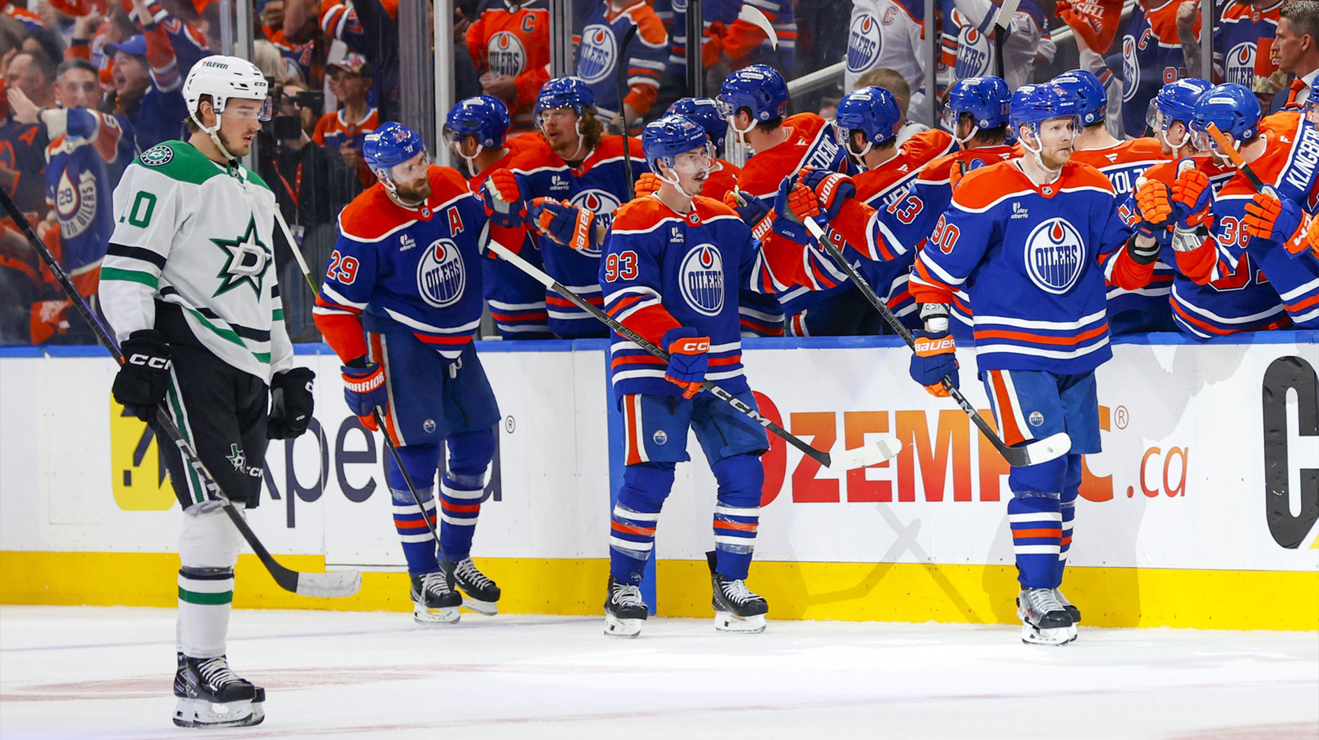 Edmonton Oilers right wing Corey Perry (90) and center Connor McDavid (97) and center Ryan Nugent-Hopkins (93) celebrates a power play goal scored by Perry against the Dallas Stars during the second period in game four of the Western Conference Final of the 2025 Stanley Cup Playoffs at Rogers Place.