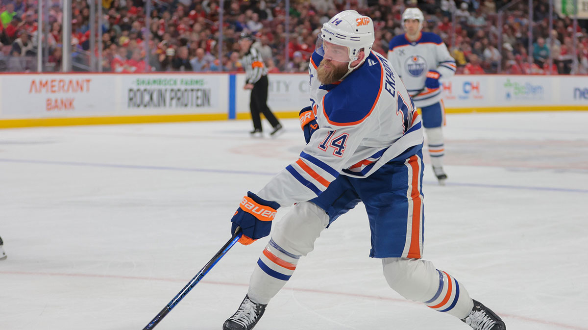 Edmonton Oilers defenseman Mattias Ekholm (14) shoots the puck against the Florida Panthers during the first period at Amerant Bank Arena.