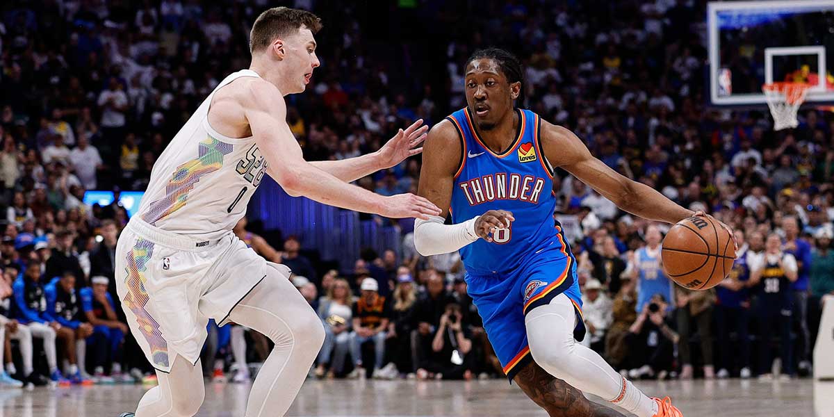Oklahoma City Thunder forward Jalen Williams (8) controls the ball as Denver Nuggets guard Christian Braun (0) guards in the second quarter during game six of the second round for the 2025 NBA Playoffs at Ball Arena.