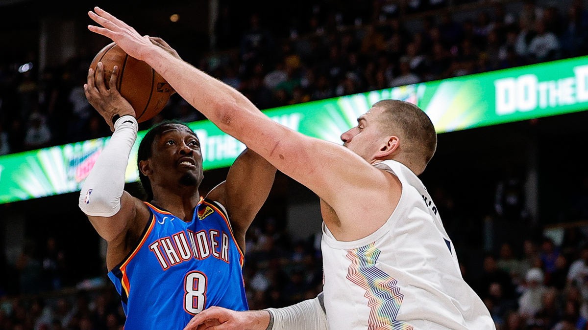 Oklahoma City Thunder forward Jalen Williams (8) controls the ball under pressure from Denver Nuggets center Nikola Jokic (15) in the first quarter during game six of the second round for the 2025 NBA Playoffs at Ball Arena.