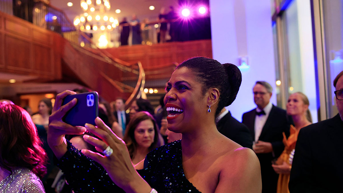 Omarosa Newman, former The Apprentice star and Donald Trump aide, claps during an inauguration ball Saturday, July 1, 2023 at The River Club in Jacksonville, Fla.