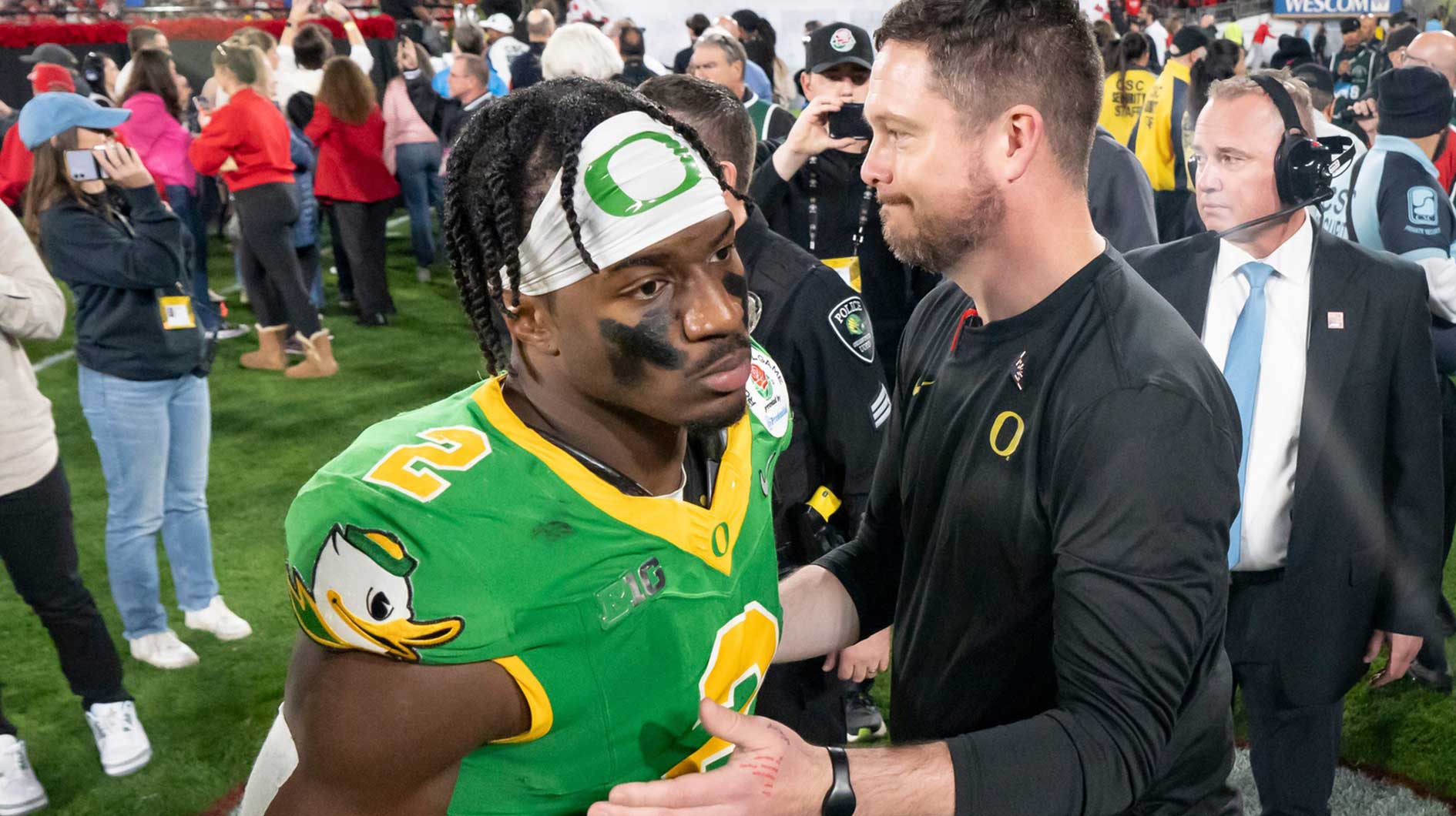 Oregon head coach Dan Lanning, right greets inside linebacker Jeffrey Bassa as the team walks off the field as the Oregon Ducks face the Ohio State Buckeyes Wednesday, Jan. 1, 2025, in the quarterfinal of the College Football Playoff at the Rose Bowl in Pasadena, Calif.