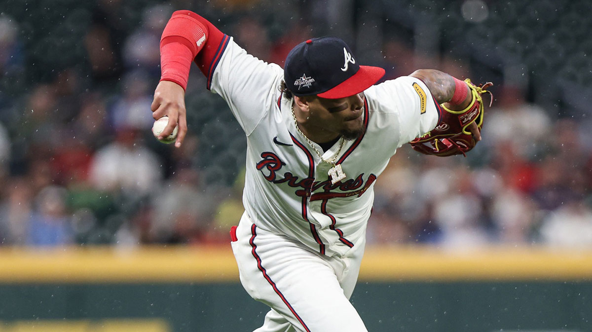 Atlanta Braves shortstop Orlando Arcia (11) fields the ball and attempts for an out against the St. Louis Cardinals during the eighth inning at Truist Park.
