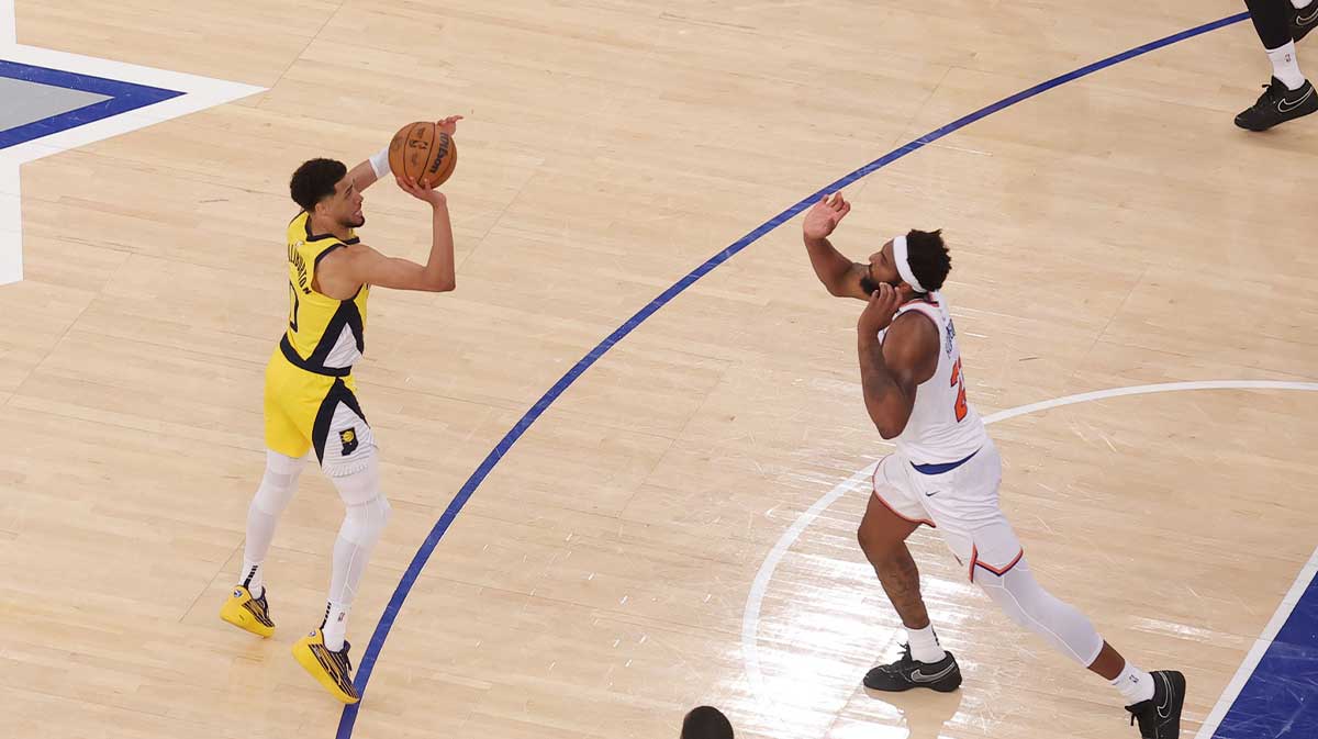 Indiana Pacers guard Tyrese Haliburton (0) shoots a game-tying two point shot to send the game to overtime in the fourth quarter against New York Knicks center Mitchell Robinson (23) during game one of the eastern conference finals for the 2025 NBA Playoffs at Madison Square Garden.