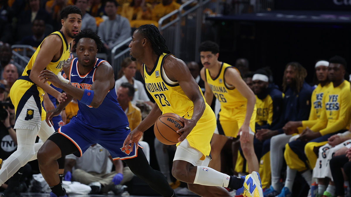 Indiana Pacers forward Aaron Nesmith (23) dribbles downcourt past New York Knicks forward OG Anunoby (8) during the second quarter of game three of the eastern conference finals for the 2025 NBA Playoffs at Gainbridge Fieldhouse.