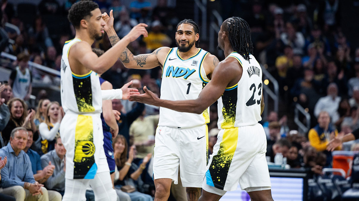 Indiana Pacers forward Obi Toppin (1) celebrates with guard Tyrese Haliburton (0) and forward Aaron Nesmith (23) in the second half against the Charlotte Hornets at Gainbridge Fieldhouse.