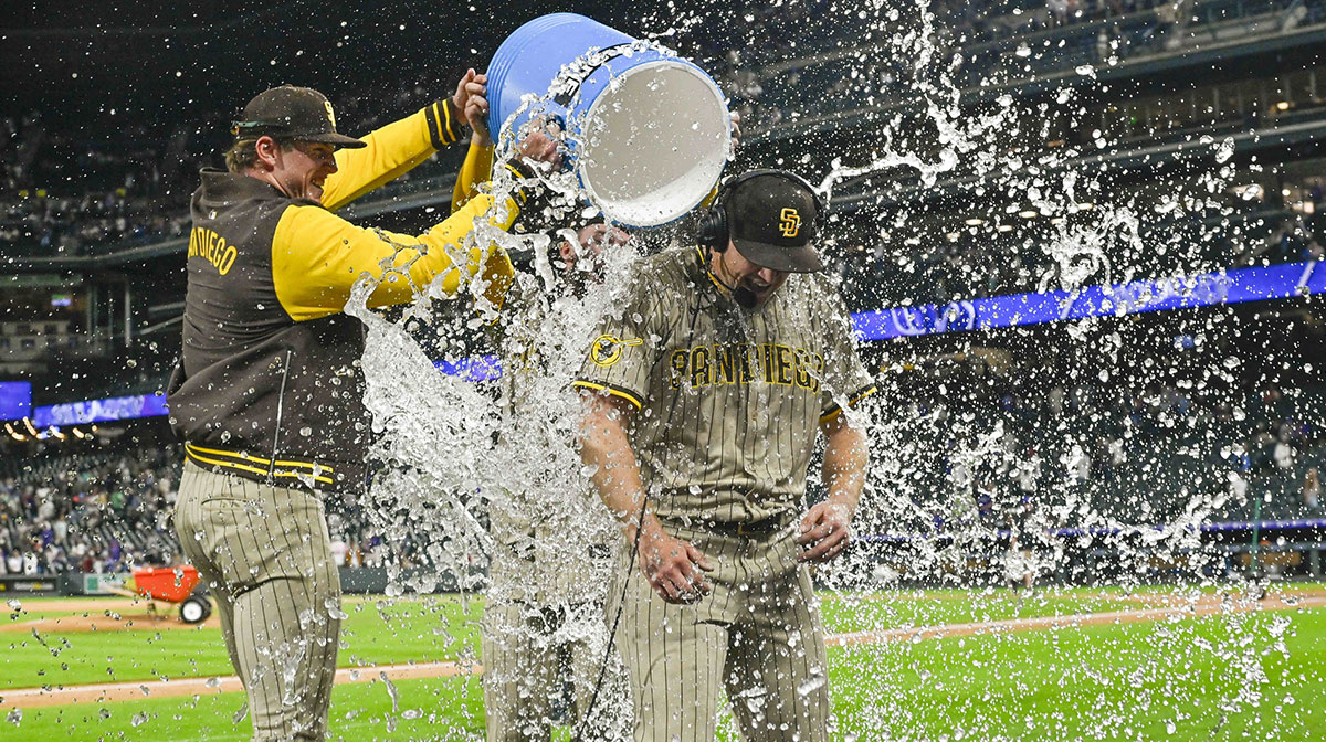 San Diego Padres pitcher Stephen Kolek (32) gets water dumped on him after his complete game and shutout of the Colorado Rockies at Coors Field.