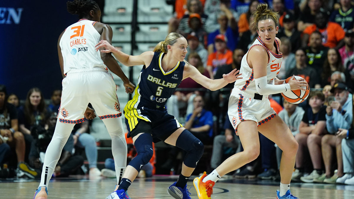 Dallas Wings guard Paige Bueckers (5) defends against Connecticut Sun center Tina Charles (31) and guard Marina Mabrey (3) in the first half at Mohegan Sun Arena.