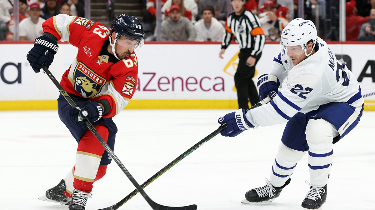 Florida Panthers center Brad Marchand (63) and Toronto Maple Leafs defenseman Jake McCabe (22) fight to control the puck during the second period in game four of the second round of the 2025 Stanley Cup Playoffs at Amerant Bank Arena.