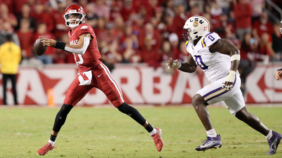 Arkansas Razorbacks quarterback Taylen Green (10) passes as LSU Tigers defensive end Paris Shand (0) defends during the second quarter at Donald W. Reynolds Razorback Stadium.