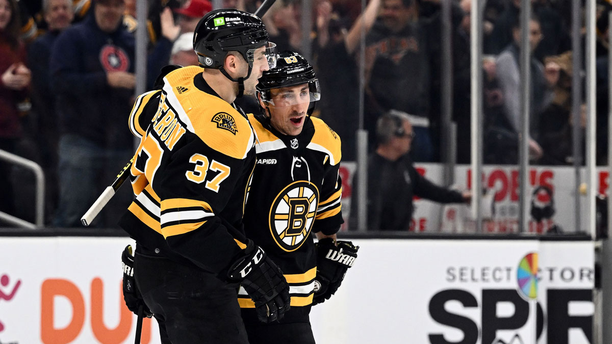 Boston Bruins left wing Brad Marchand (63) celebrates with center Patrice Bergeron (37) after scoring a goal against the Edmonton Oilers during the first period at the TD Garden.