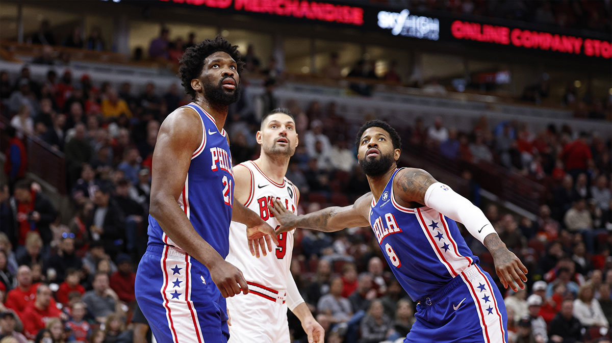 Philadelphia 76ers center Joel Embiid (21) and forward Paul George (8) defend against Chicago Bulls center Nikola Vucevic (9) during the first half at United Center.