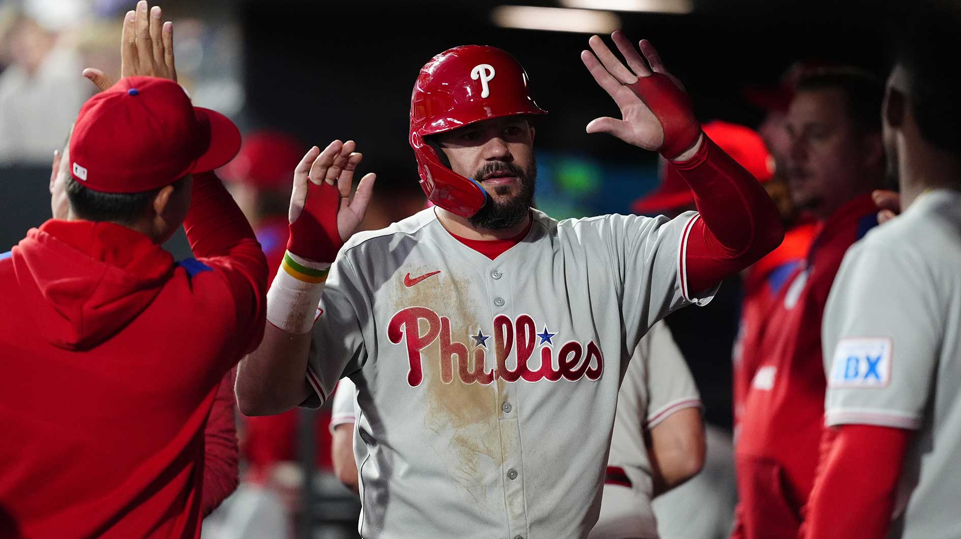Philadelphia Phillies designated hitter Kyle Schwarber (12) celebrates scoring a run in the sixth inning against the Colorado Rockies at Coors Field.