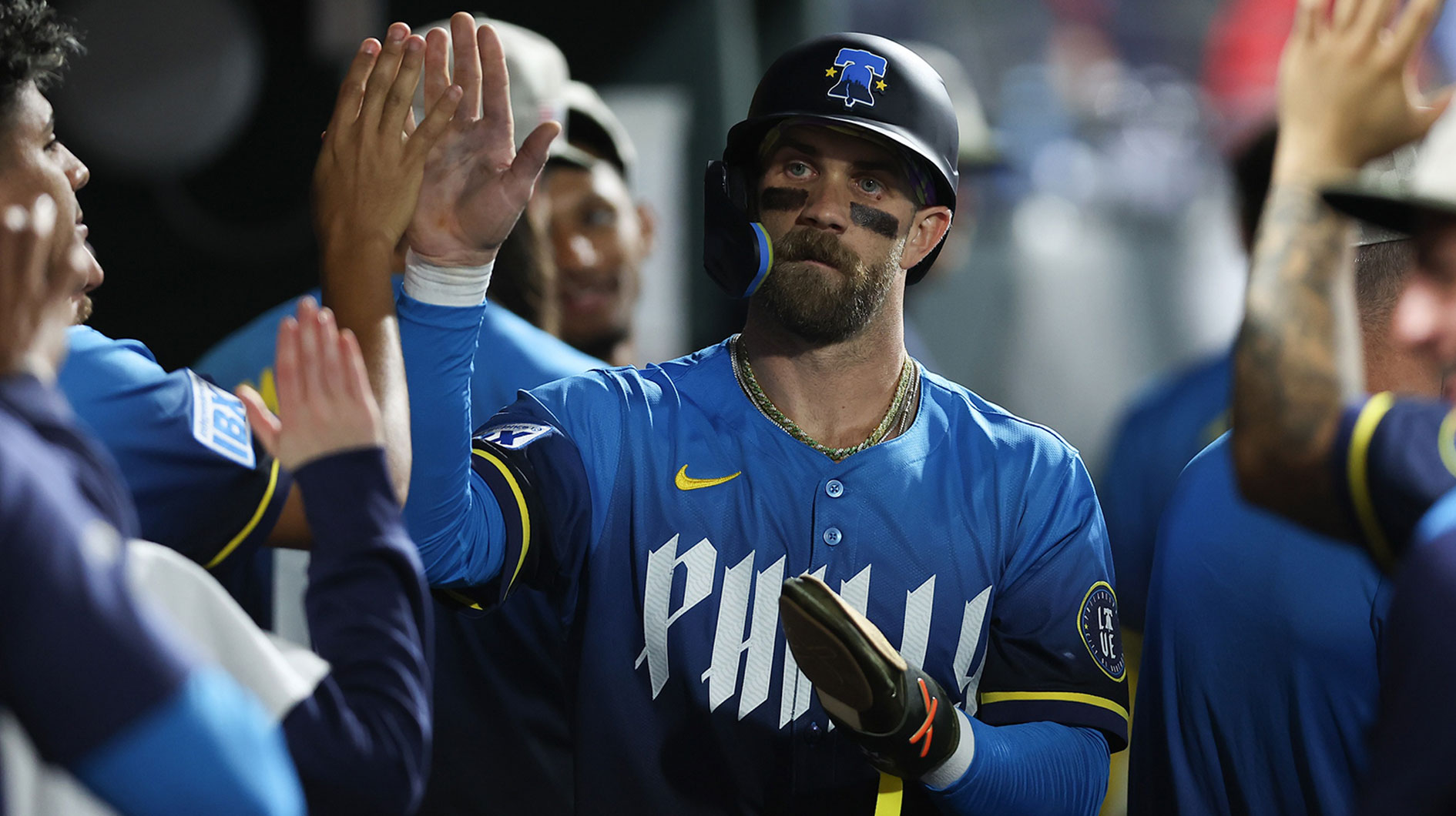 Philadelphia Phillies first base Bryce Harper (3) high fives in the dugout after scoring during the seventh inning against the Pittsburgh Pirates at Citizens Bank Park.