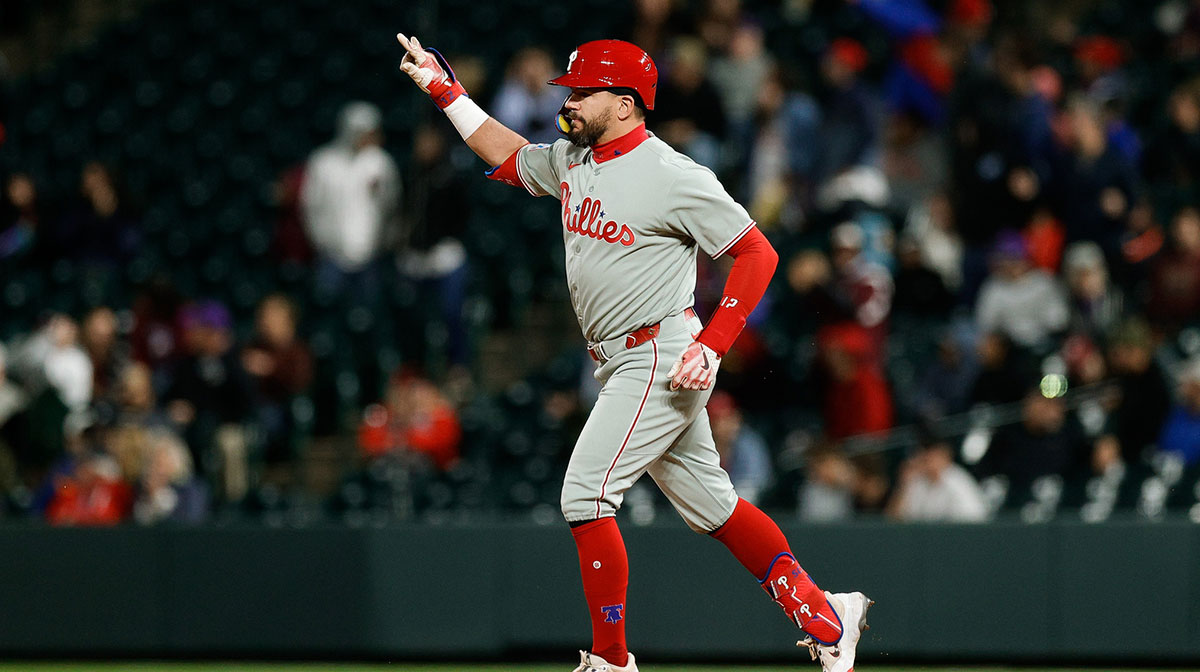 Philadelphia Phillies designated hitter Kyle Schwarber (12) gestures as he rounds the bases on a solo home run in the ninth inning against the Colorado Rockies at Coors Field.