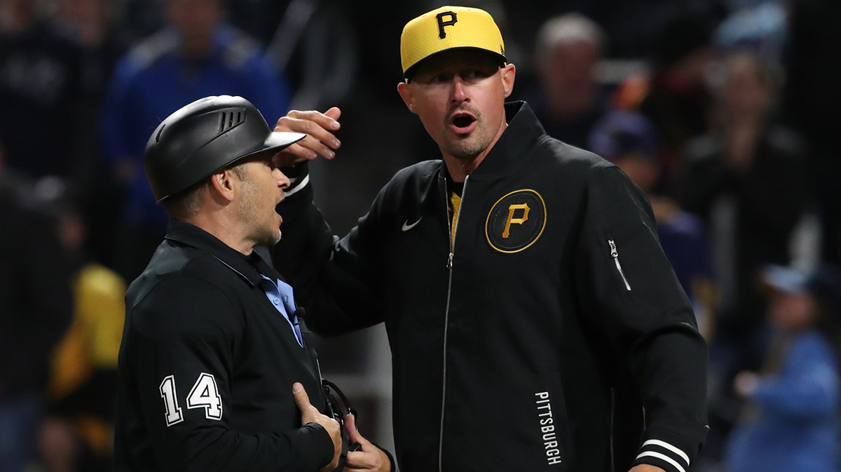 Home plate umpire Mark Wegner (14) and Pittsburgh Pirates manager Don Kelly (12) argue a play at the plate against the Milwaukee Brewers during the tenth inning at PNC Park.