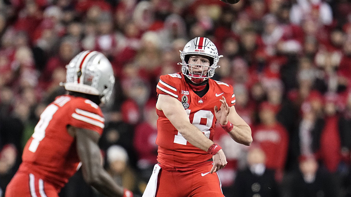 Ohio State Buckeyes quarterback Will Howard (18) throws to wide receiver Jeremiah Smith (4) during the first half of the College Football Playoff first round game against the Tennessee Volunteers at Ohio Stadium in Columbus on Dec. 21, 2024.