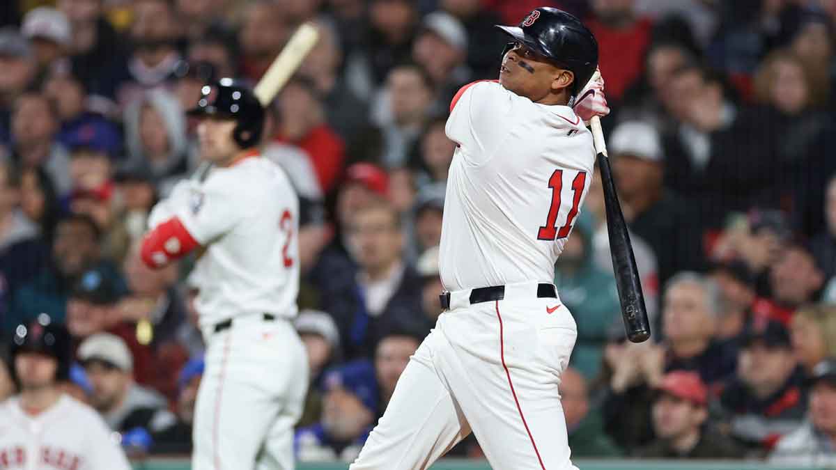 Boston Red Sox designated hitter Rafael Devers (11) hits a solo home run during the fifth inning against the New York Mets at Fenway Park.