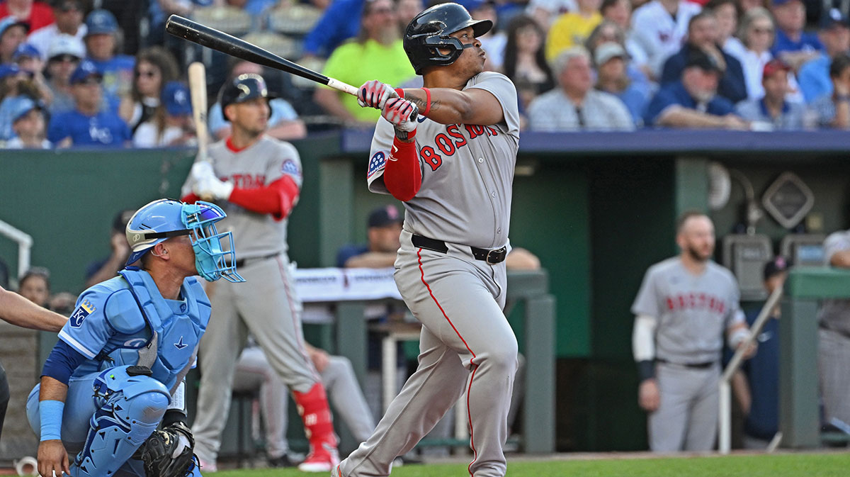 Boston Red Sox designated hitter Rafael Devers (11) hits an RBI double in the third inning against the Kansas City Royals at Kauffman Stadium.
