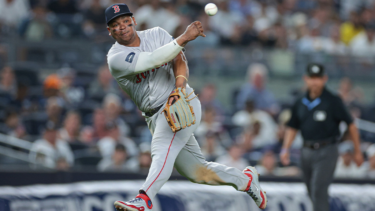Boston Red Sox third baseman Rafael Devers (11) throws the ball to first base for an out during the eighth inning against the New York Yankees at Yankee Stadium.