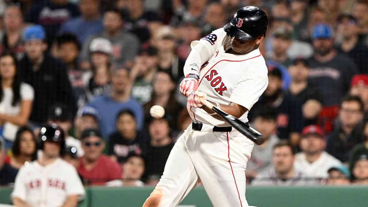May 17, 2025; Boston, Massachusetts, USA; Boston Red Sox designated hitter Rafael Devers (11) hits a walk off home run against the Atlanta Braves during the ninth inning at Fenway Park.
