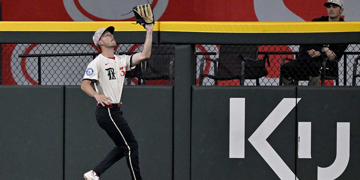 Texas Rangers center fielder Evan Carter (32) catches a fly ball hit by Houston Astros designated hitter Yainer Diaz (not pictured) during the fourth inning at Globe Life Field.