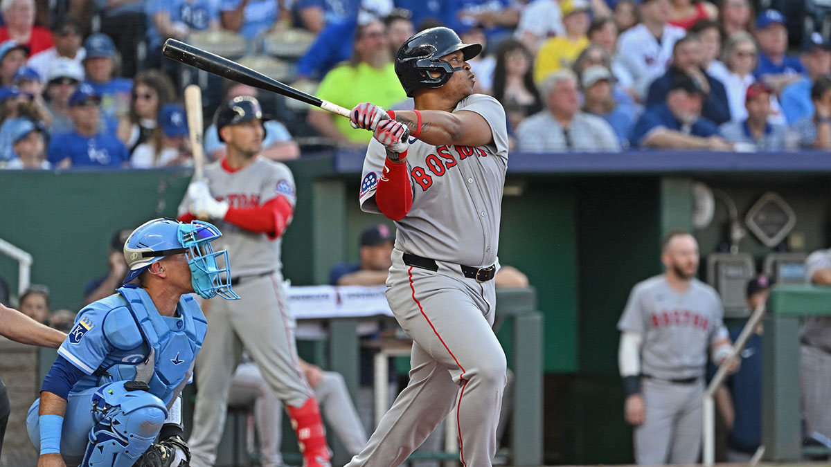 Boston Red Sox designated hitter Rafael Devers (11) hits an RBI double in the third inning against the Kansas City Royals at Kauffman Stadium.