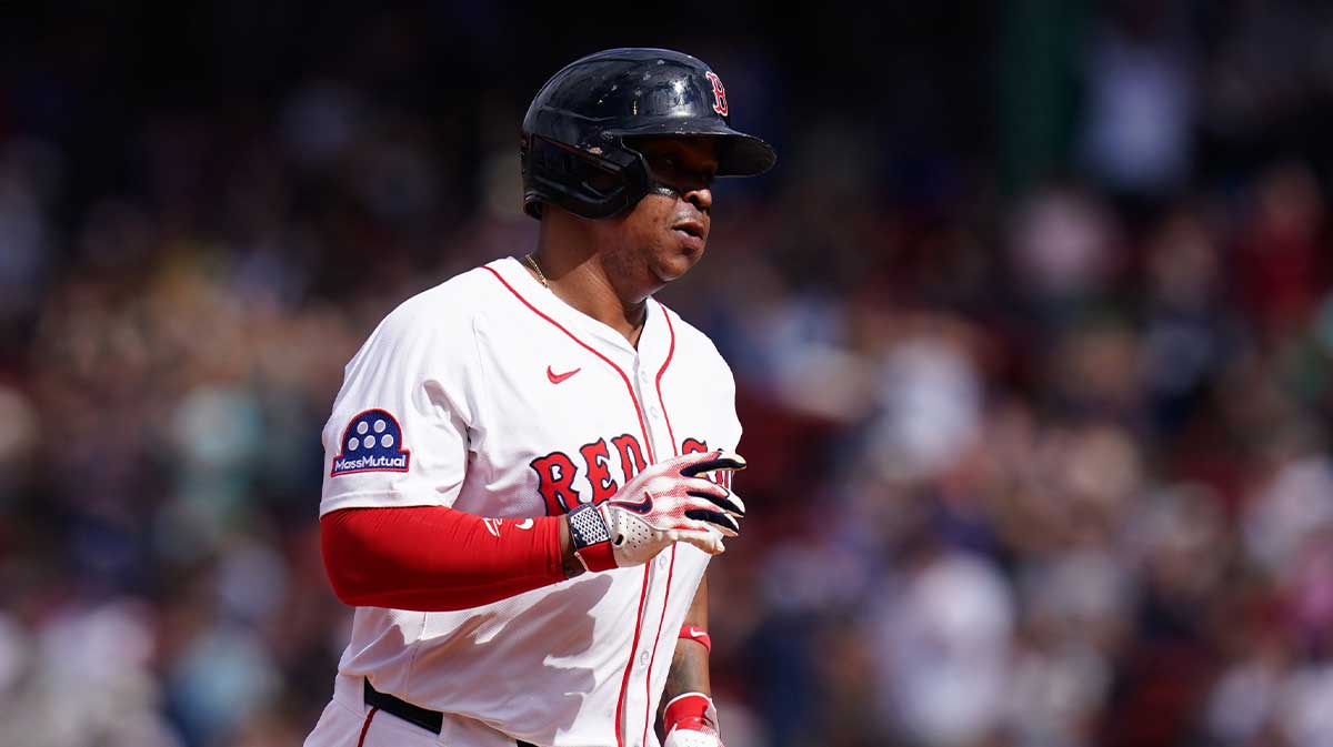 Boston Red Sox designated hitter Rafael Devers (11) hits a home run against the Texas Rangers in the seventh inning at Fenway Park.