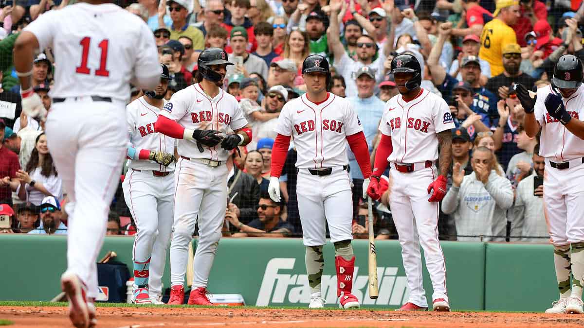 May 18, 2025; Boston, Massachusetts, USA; Boston Red Sox left fielder Jarren Duran (16) center fielder Ceddanne Rafaela (3) and second baseman David Hamilton (17) wait at home to congratulate designated hitter Rafael Devers (11) after hitting a grand slam during the fourth inning against the Atlanta Braves at Fenway Park. Mandatory Credit: Bob DeChiara-Imagn Images