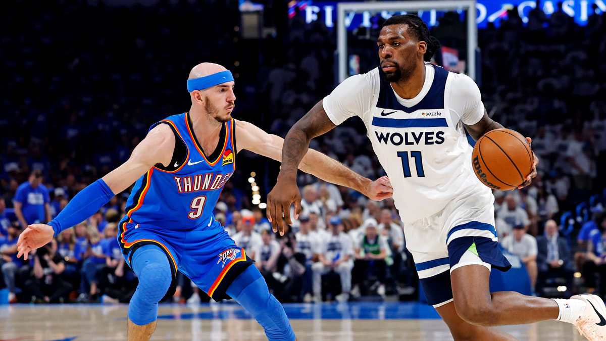 Minnesota Timberwolves center Naz Reid (11) drives to the basket against Oklahoma City Thunder guard Alex Caruso (9) during the second quarter in game five of the western conference finals for the 2025 NBA Playoffs at Paycom Center.