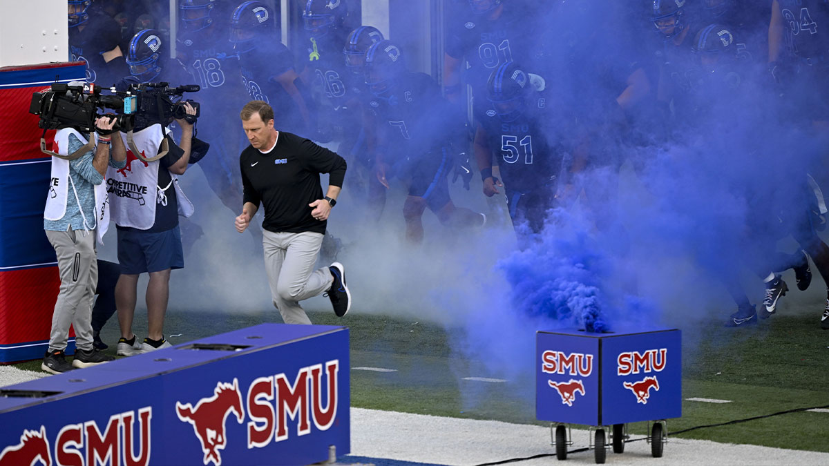 SMU Mustangs head coach Rhett Lashlee leads his team on to the field before the game between the SMU Mustangs and the Boston College Eagles at Gerald J. Ford Stadium.