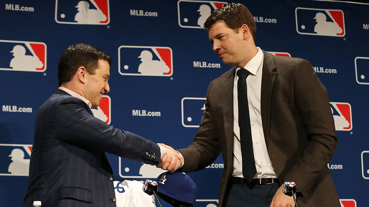 Los Angeles Dodgers president of baseball operations Andrew Friedman (left) shakes hands with Dodgers pitcher Rich Hill (right) at a press conference announcing Hill's signing a three year contract during the 2016 MLB Winter Meetings.