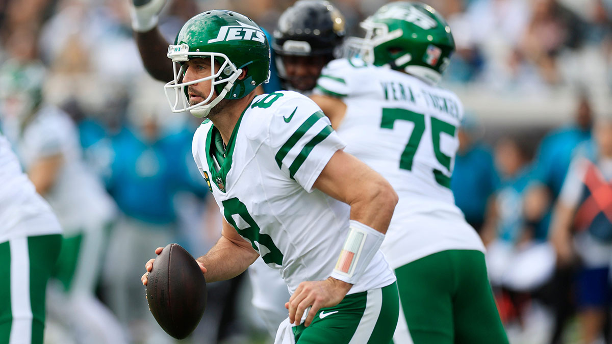 New York Jets quarterback Aaron Rodgers (8) is pressured in the pocket during the first quarter.