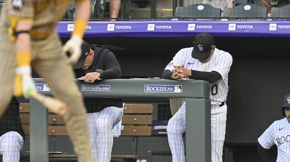 Colorado Rockies manager Bud Black (10) stands on the top step of the dugout with his head down during their game against the San Diego Padres at Coors Field.