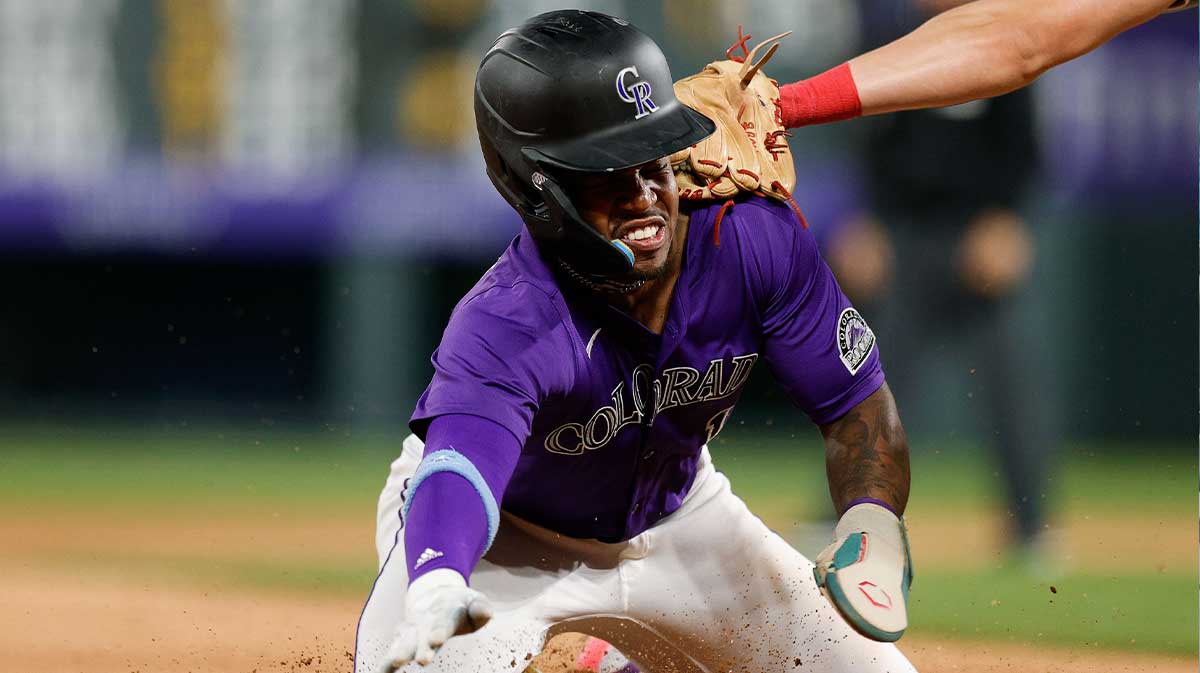 Colorado Rockies second baseman Adael Amador (1) is tagged out attempting to reach third in the seventh inning against the Philadelphia Phillies at Coors Field.