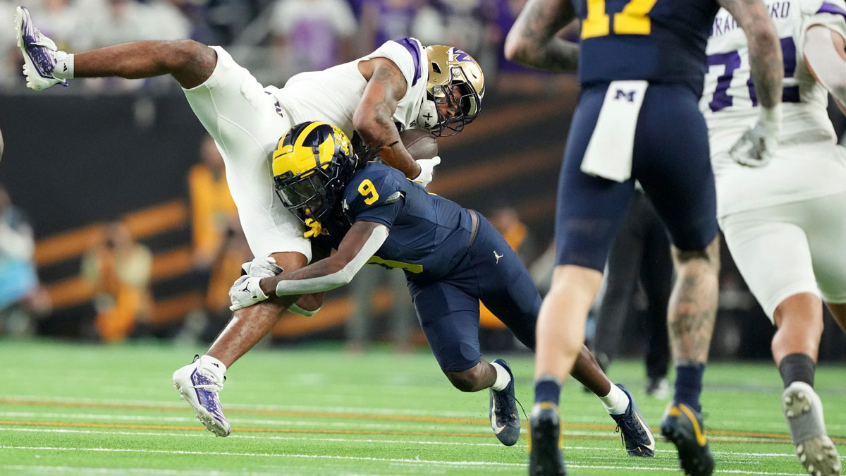 Washington wide receiver Ja'Lynn Polk is tackled by Michigan defensive back Rod Moore during the second half of the College Football Playoff national championship game against Washington at NRG Stadium