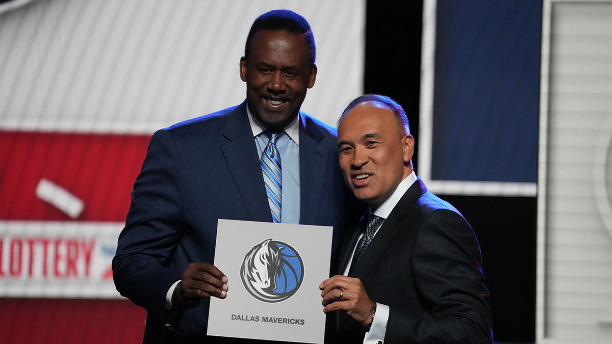 Rolando Blackman of the Dallas Mavericks poses with Mark Tatum NBA Deputy Commissioner after winning the the first pick during the 2025 NBA Draft Lottery at McCormick Place.